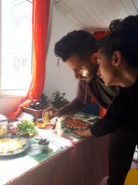 Side view of a man having food at home