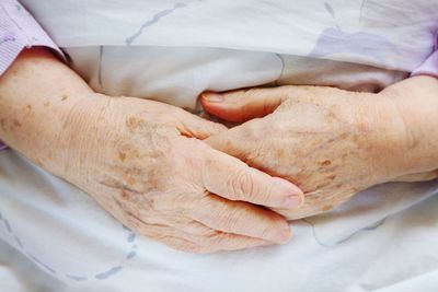 Hands of an old woman in bad