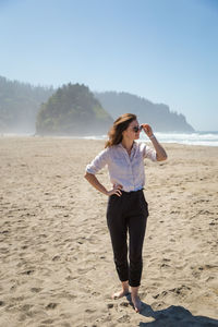 Full length of woman standing on beach