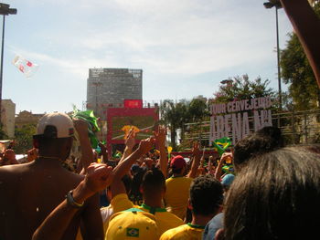 People on street in city against sky