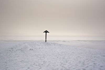 Snow covered land against sky