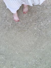 Low section of woman standing on tiled floor