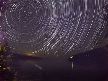 Low angle view of fireworks against sky at night