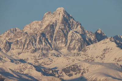 Scenic view of snowcapped mountains against clear sky