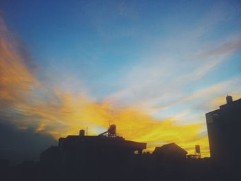 Low angle view of building against sky at sunset