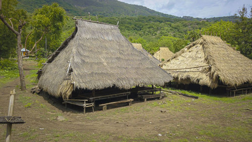 Scenic view of village on field by mountain