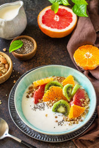 Healthy breakfast. bowl of homemade granola with yoghurt, fresh fruit, nuts and chia seeds. 