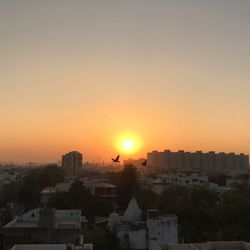 Cityscape against sky during sunset