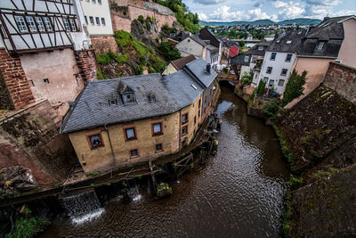 High angle view of canal amidst buildings in city