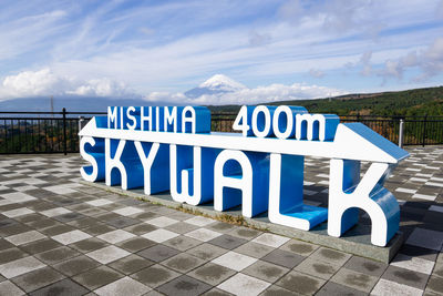 Information sign against blue sky