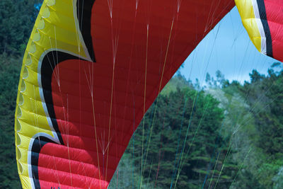 Close-up of paragliding canopy and multi-coloured strings