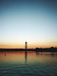 Silhouette tower against clear sky during sunset