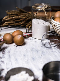 Close-up of eggs with flour on table