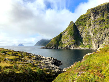 Scenic view of sea and mountains against sky