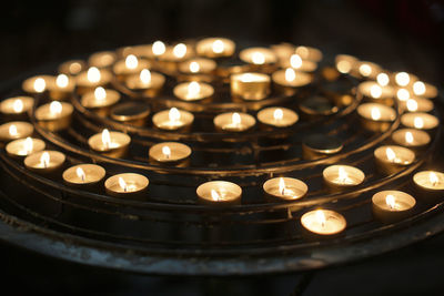 High angle view of burning candles on metal