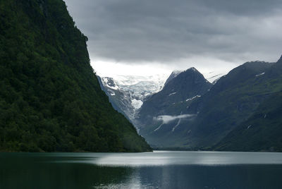 Scenic view of lake and mountains against sky