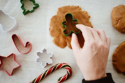 High angle view of hand holding cookies on table