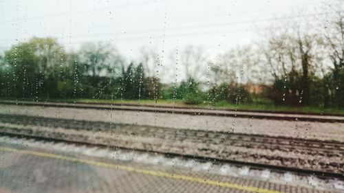 Road seen through wet car window