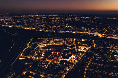 High angle view of illuminated city buildings at night