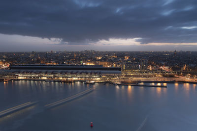 Aerial view of illuminated city against sky at night