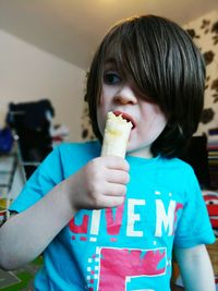 Close-up of boy eating banana