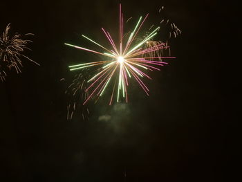 Low angle view of firework display at night