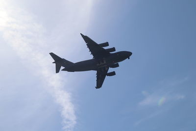 Low angle view of airplane flying against sky
