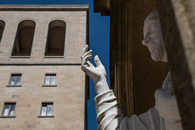 Low angle view of man standing against building