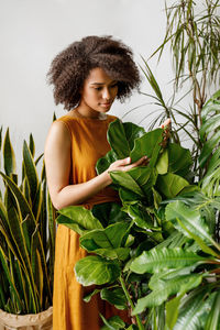 Young woman looking at plants