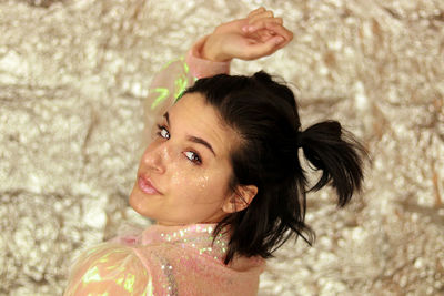 Side view of young woman holding flower