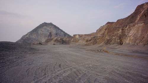 Scenic view of arid landscape against sky