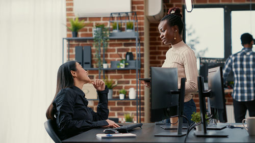 Business colleagues talking at office