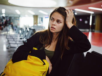 Portrait of young woman sitting on floor