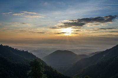 Scenic view of silhouette mountains against sky at sunset