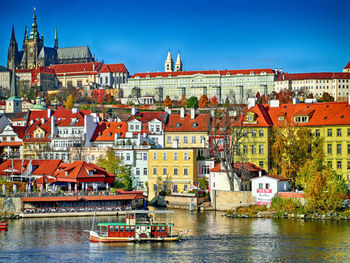 Boats in river with buildings in background