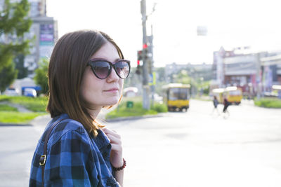Woman wearing sunglasses on road