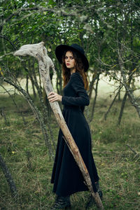 Portrait of young woman standing in forest