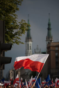 View of people holding flags against clear sky