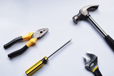 High angle view of tools on table against white background