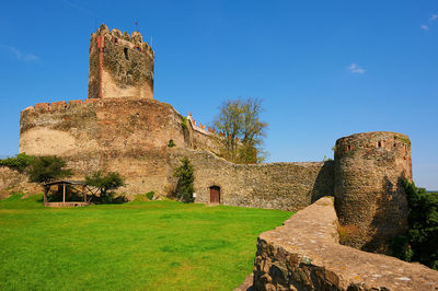 Old ruin building against blue sky