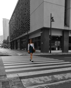 Full length of man walking on road in city