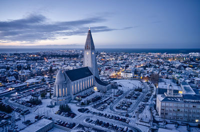 Majestic church on snowy city street in evening