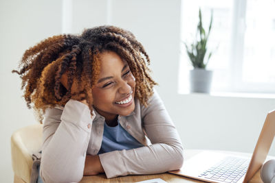 Young woman using laptop at home