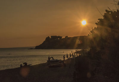 Scenic view of beach against sky during sunset