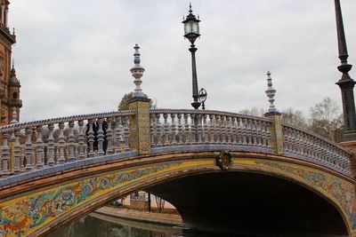 Low angle view of historical building bridge against sky