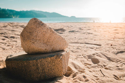 Close-up of pebbles on beach against sky