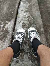 Low section of man standing on footpath