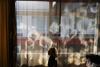 People looking through glass window