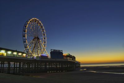 Central pier against sky at sunset