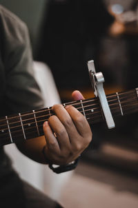 Cropped image of man playing guitar